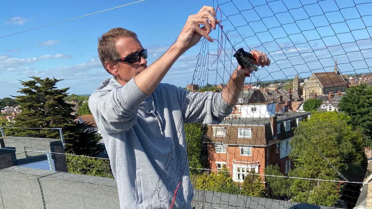 Ben from BMS imstalling Pigeon netting